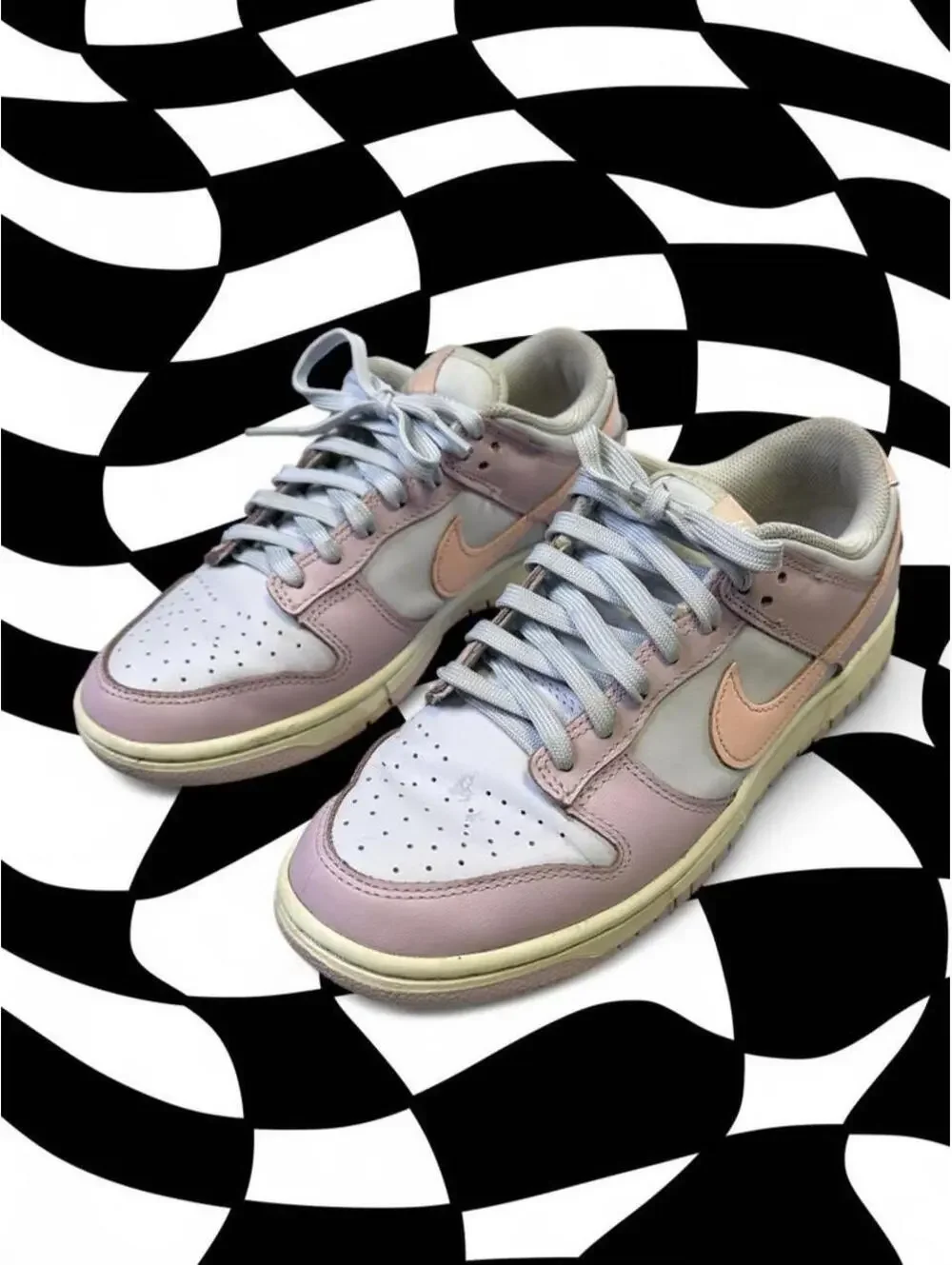 Nike Dunk Low Easter sneakers in pink, white, and peach with a Nike swoosh
